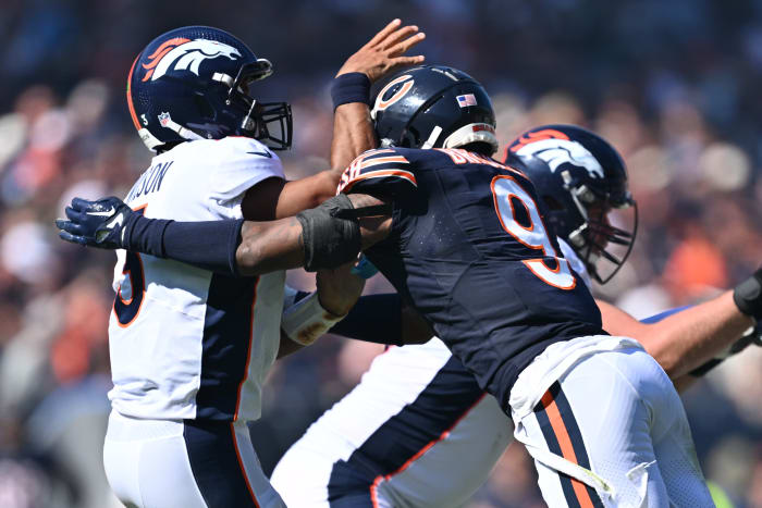 Chicago Bears safety Jaquan Brisker (9) chases Denver Broncos quarterback Russell Wilson (3) at Soldier Field Sunday.